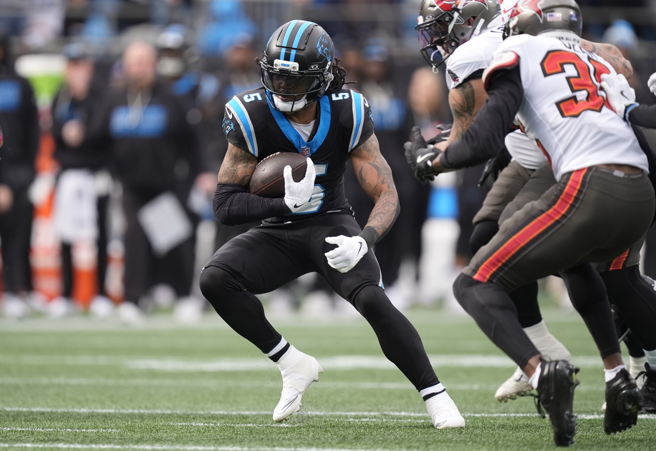 Rico Dowdle runs during the first half against the Tampa Bay Buccaneers as we offer our Panthers vs. Buccaneers predictions for Saturday.