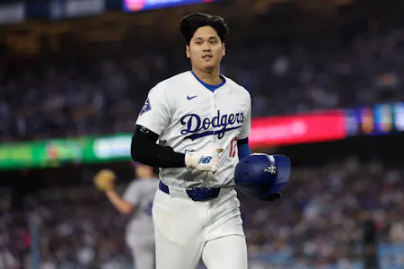 Los Angeles Dodgers designated hitter Shohei Ohtani runs back to the dugout after getting an out on a pick-off play during the third inning at Dodger Stadium as we look at our Dodgres-Yankees player props.