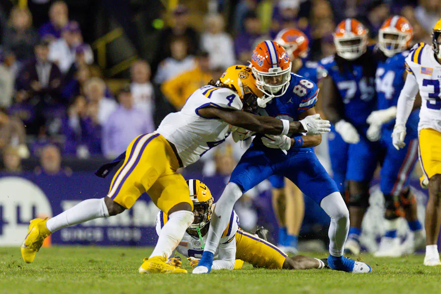 LSU linebacker Harold Perkins Jr. tackles Florida wide receiver Marcus Burke. We're backing the Tigers in our USC vs. LSU Parlay.
