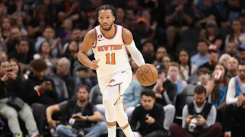 Jalen Brunson of the New York Knicks handles the ball during the first half of the NBA game at Footprint Center.