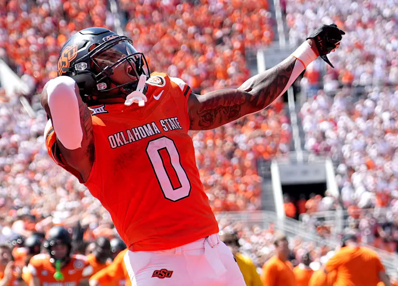 Oklahoma State's Ollie Gordon II celebrates in the second half against the Arkansas Razorbacks as we look at our Utah vs. Oklahoma State prediction.