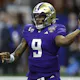 Michael Penix Jr. of the Washington Huskies throws a pass during the fourth quarter against the Texas Longhorns during the CFP Semifinal Allstate Sugar Bowl as we look at our BetRivers promo code for Washington-Michigan.