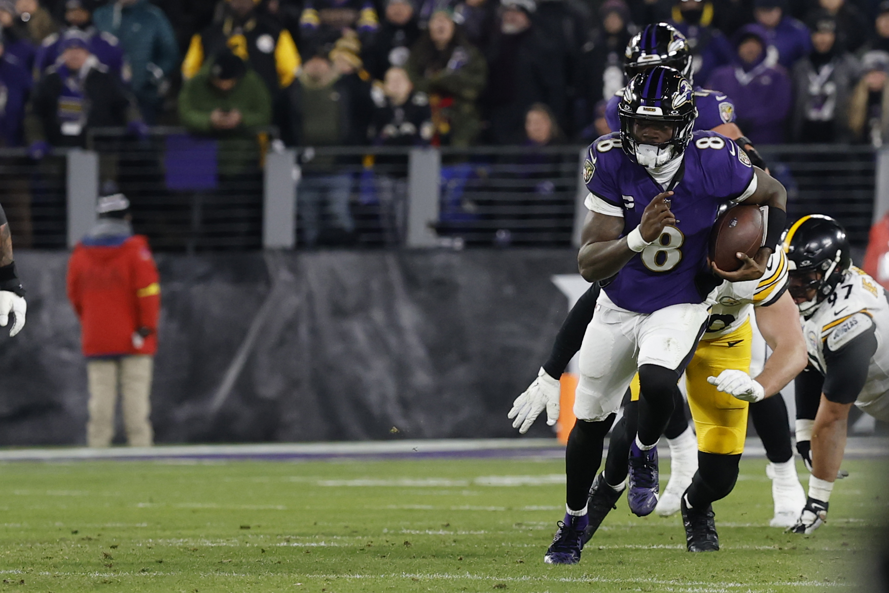 Baltimore Ravens quarterback Lamar Jackson runs with the ball against the Pittsburgh Steelers as we offer our Lamar Jackson player prop odds.  