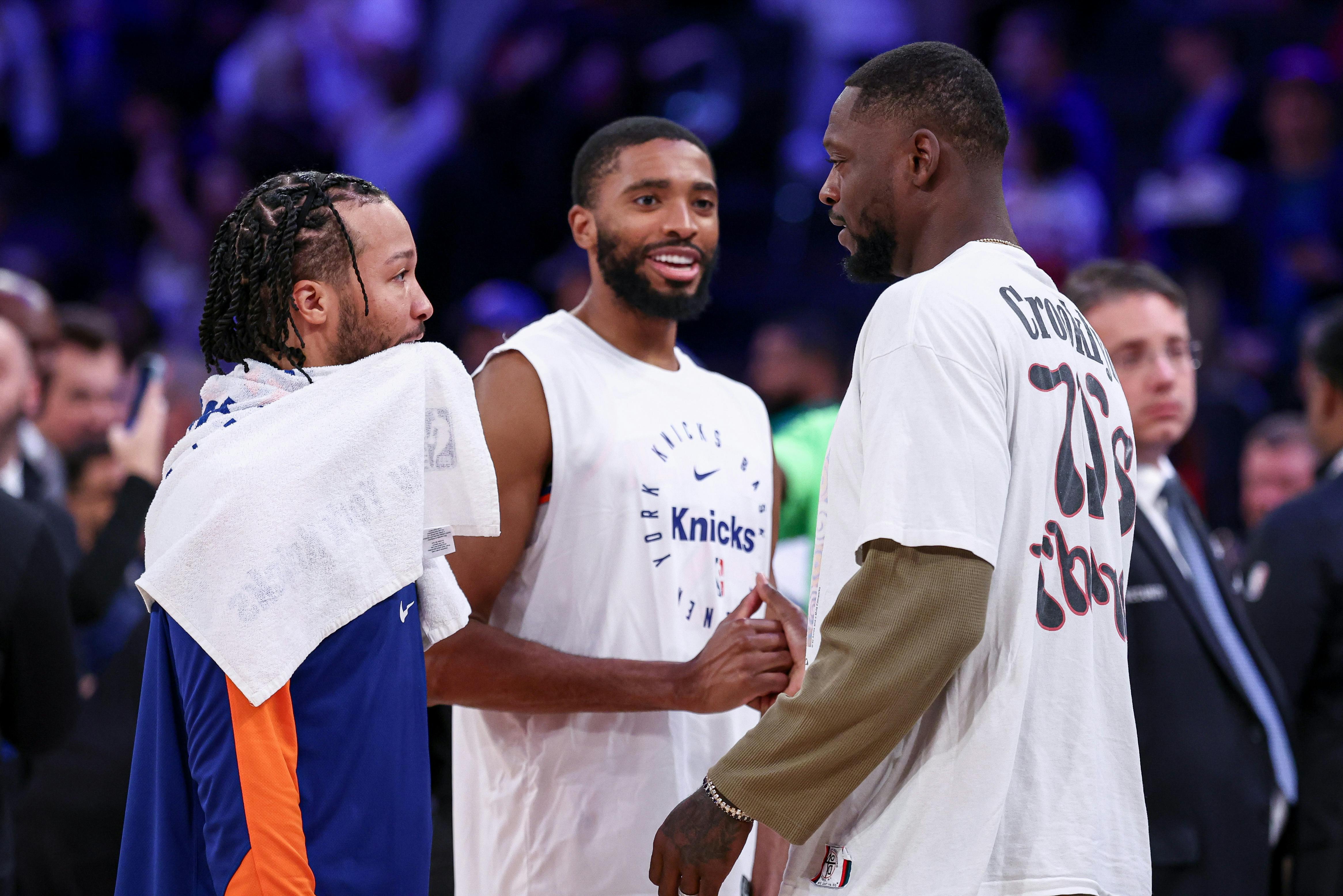 New York Knicks guard Jalen Brunson, left, and forward Mikal Bridges, center, talk with Minnesota Timberwolves forward Julius Randle, right, after the game at Madison Square Garden.