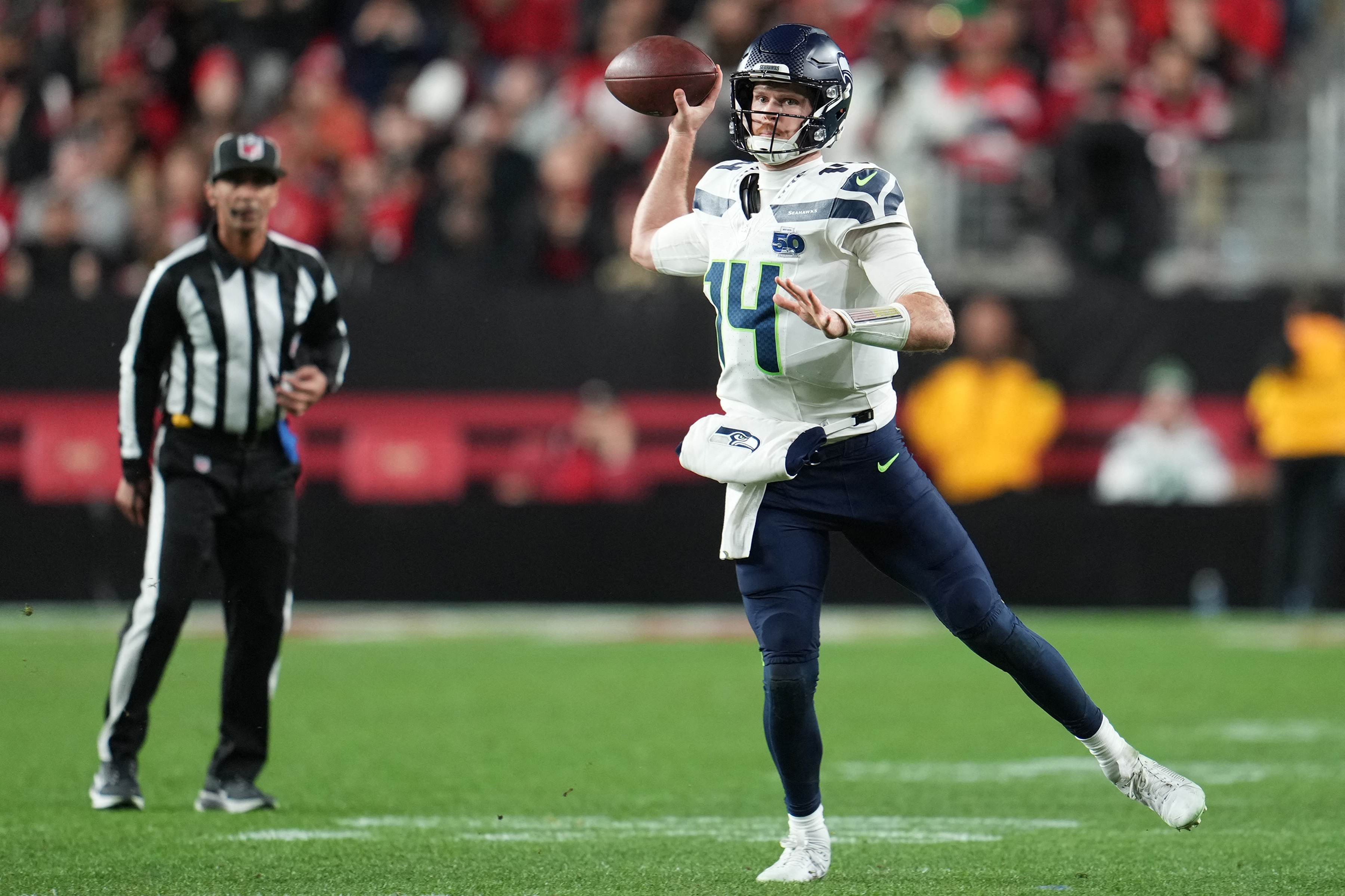 Seattle Seahawks quarterback Sam Darnold (14) drops back to pass as we break down our 49ers vs. Seahawks predictions.