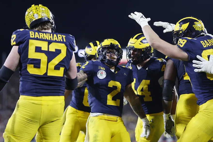 Blake Corum of the Michigan Wolverines celebrates with teammates as we share our best Washington vs. Michigan same-game parlay.