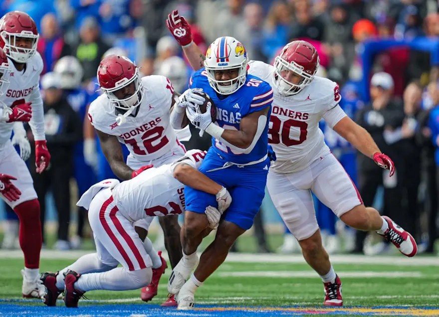 Running back Daniel Hishaw Jr. of the Kansas Jayhawks is tackled as we look at our college football prop picks for Week 10.