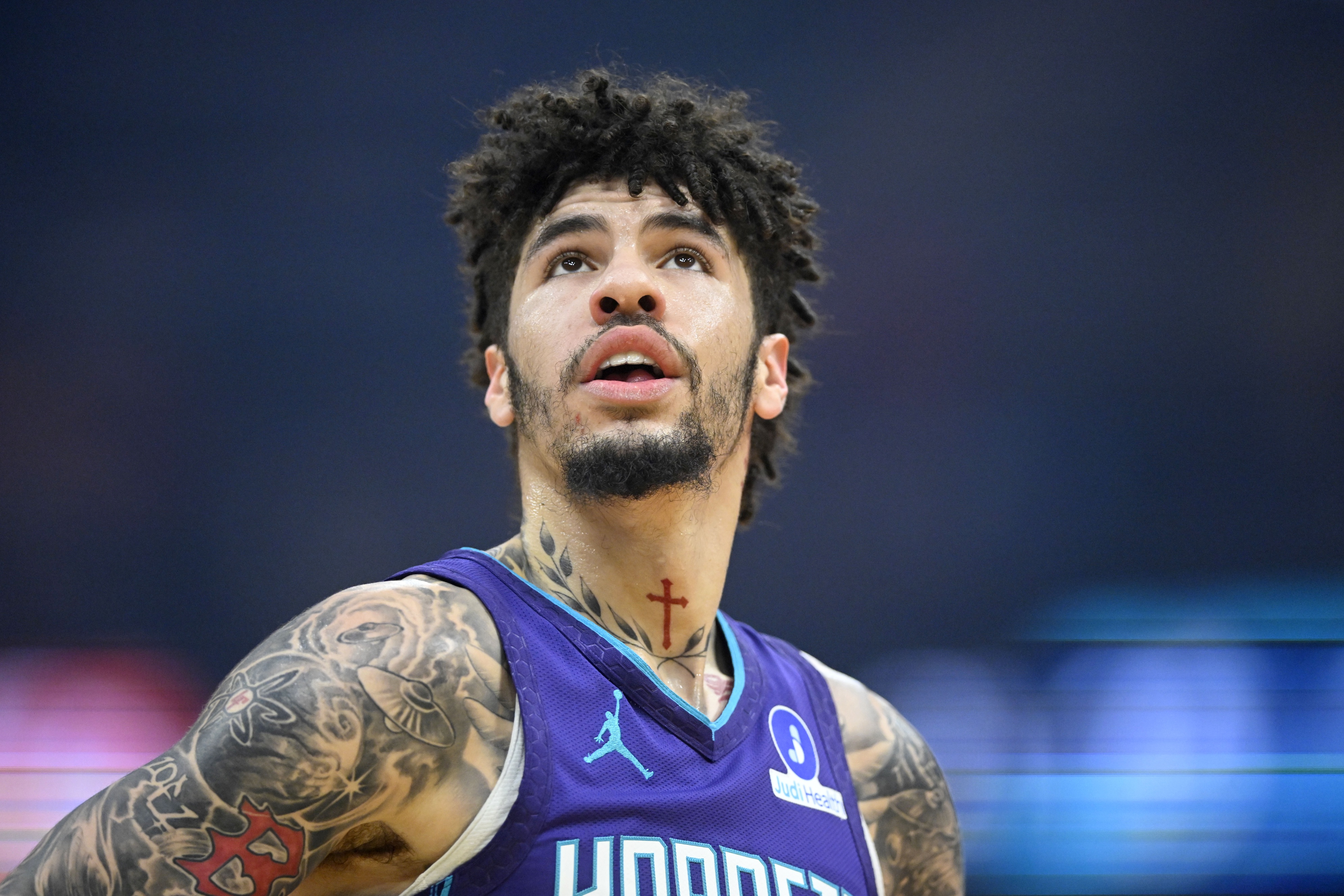 Charlotte Hornets guard Lamelo Ball (1), seen here standing on the court, is featured in our best NBA player props today.