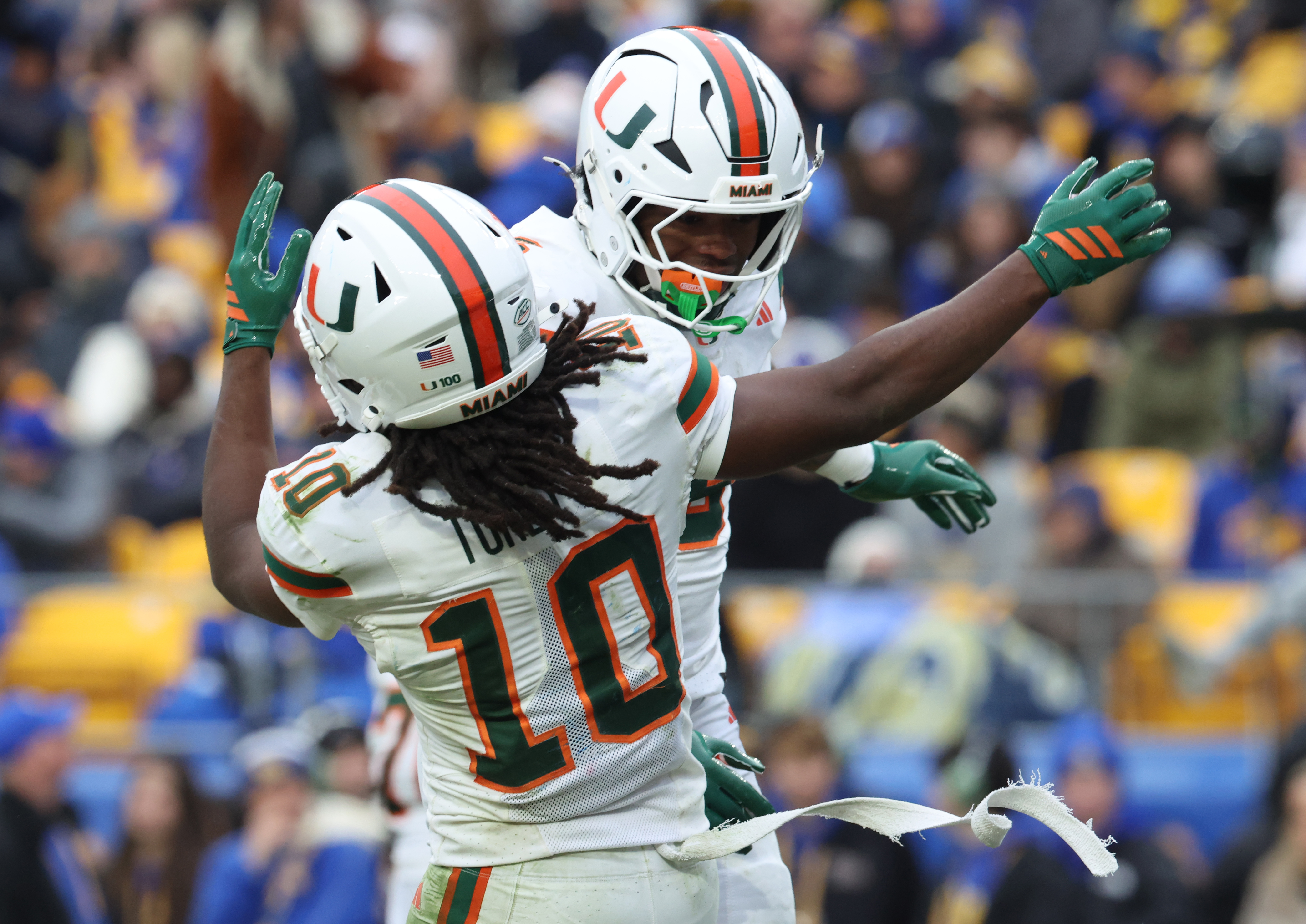 Miami wide receiver Malachi Toney (10) and running back CharMar Brown (right) celebrate a touchdown as we look at the college bowl game odds