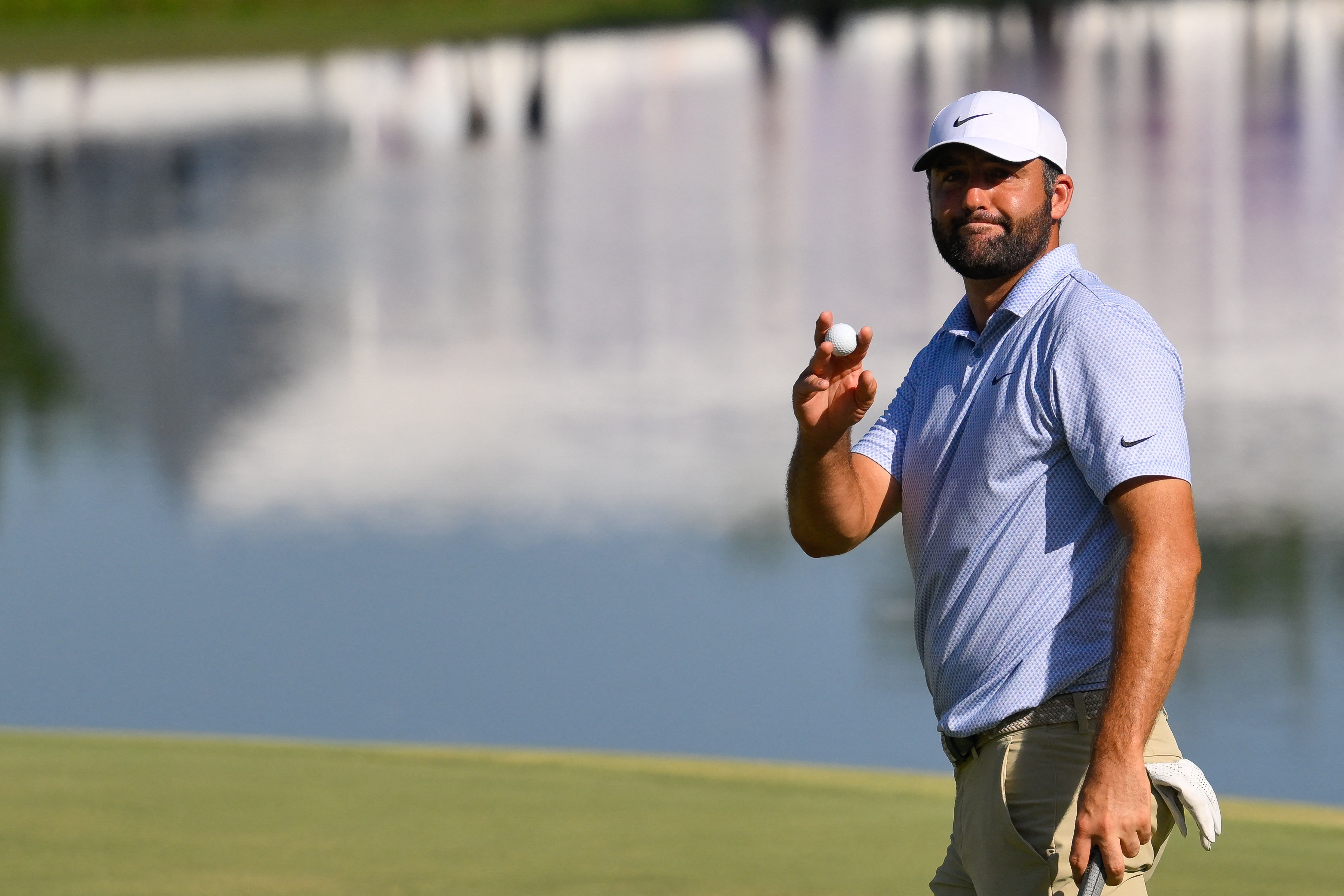 Scottie Scheffler waves to the crowd after winning as he is featured in our BMW Championship odds.