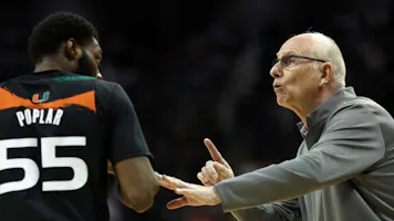 Head coach Jim Larrañaga of the Miami Hurricanes talks with Wooga Poplar during the Elite Eight round of the NCAA Men's Basketball Tournament at T-Mobile Center in Kansas City, Missouri. Photo by Jamie Squire/Getty Images via AFP.