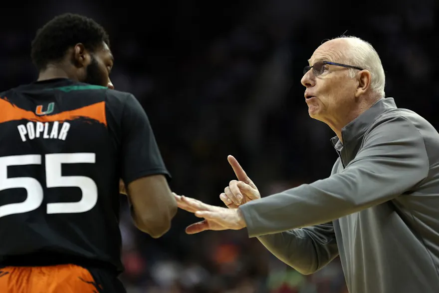 Head coach Jim Larrañaga of the Miami Hurricanes talks with Wooga Poplar during the Elite Eight round of the NCAA Men's Basketball Tournament at T-Mobile Center in Kansas City, Missouri. Photo by Jamie Squire/Getty Images via AFP.