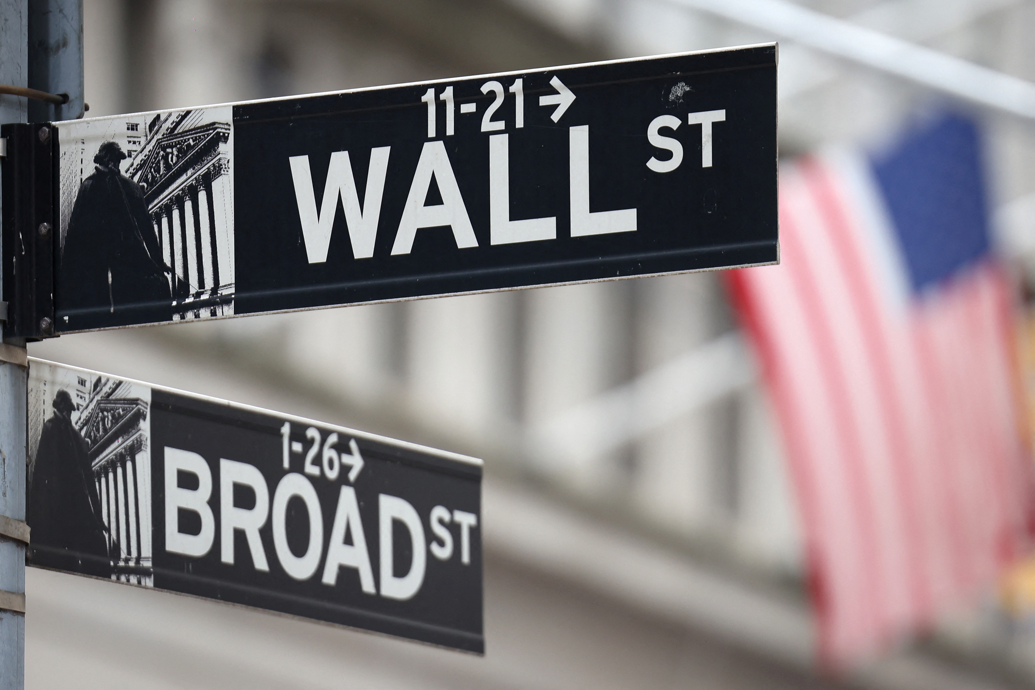 A Wall Street sign hangs as we look at the comparison of insider trading at Wall Street stocks and prediction markets.