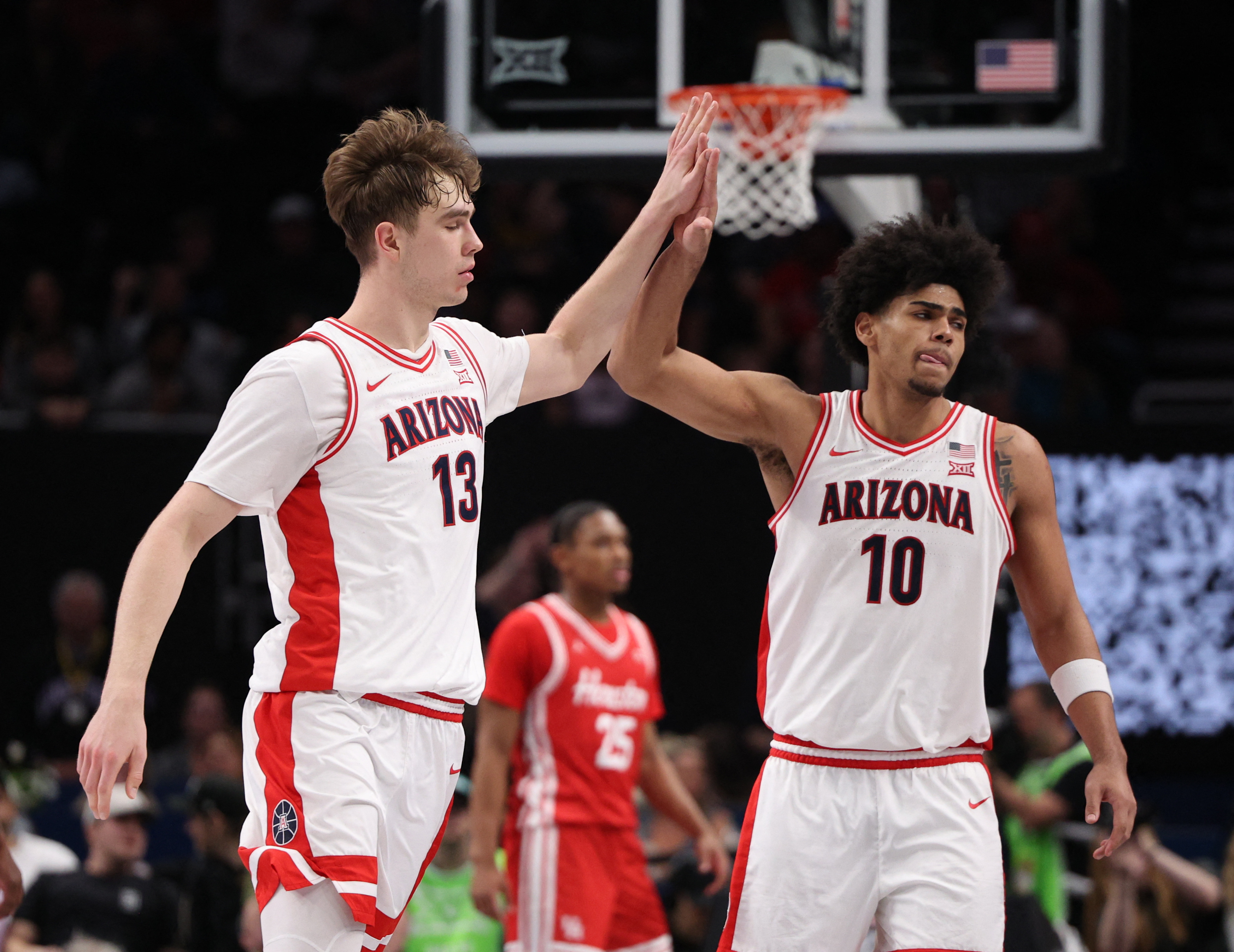 Arizona Wildcats center Motiejus Krivas (13) and forward Koa Peat (10) high-five against the Houston Cougars. Arizona leads our West Region predictions.