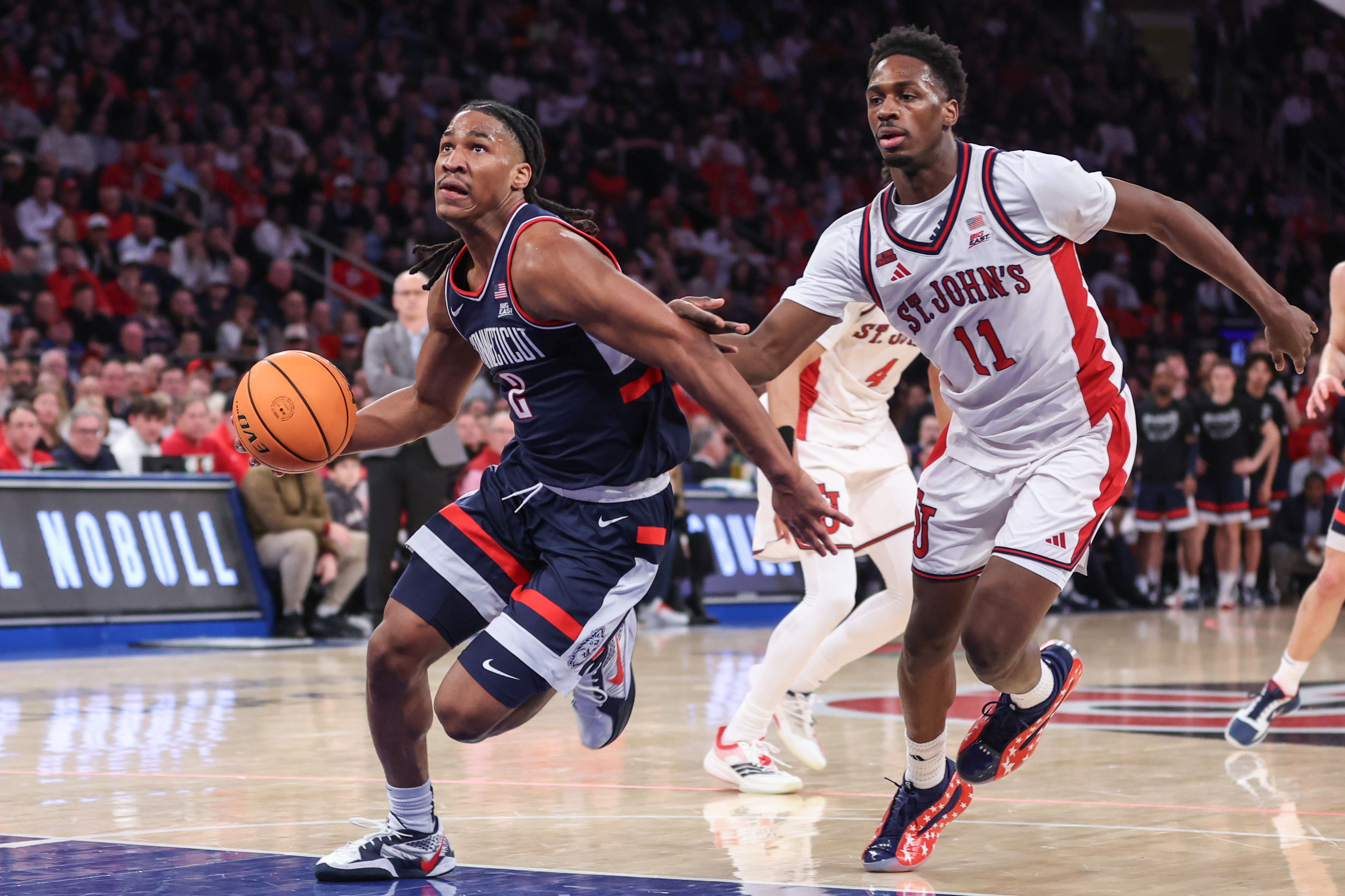 UConn's Silas Demary Jr. (2) leads the Huskies against St. John's in the biggest game of our college basketball predictions today.
