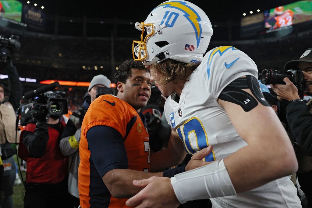 Russell Wilson #3 of the Denver Broncos and Justin Herbert #10 of the Los Angeles Chargers shake hands as we look at our 2023 NFL betting guide.