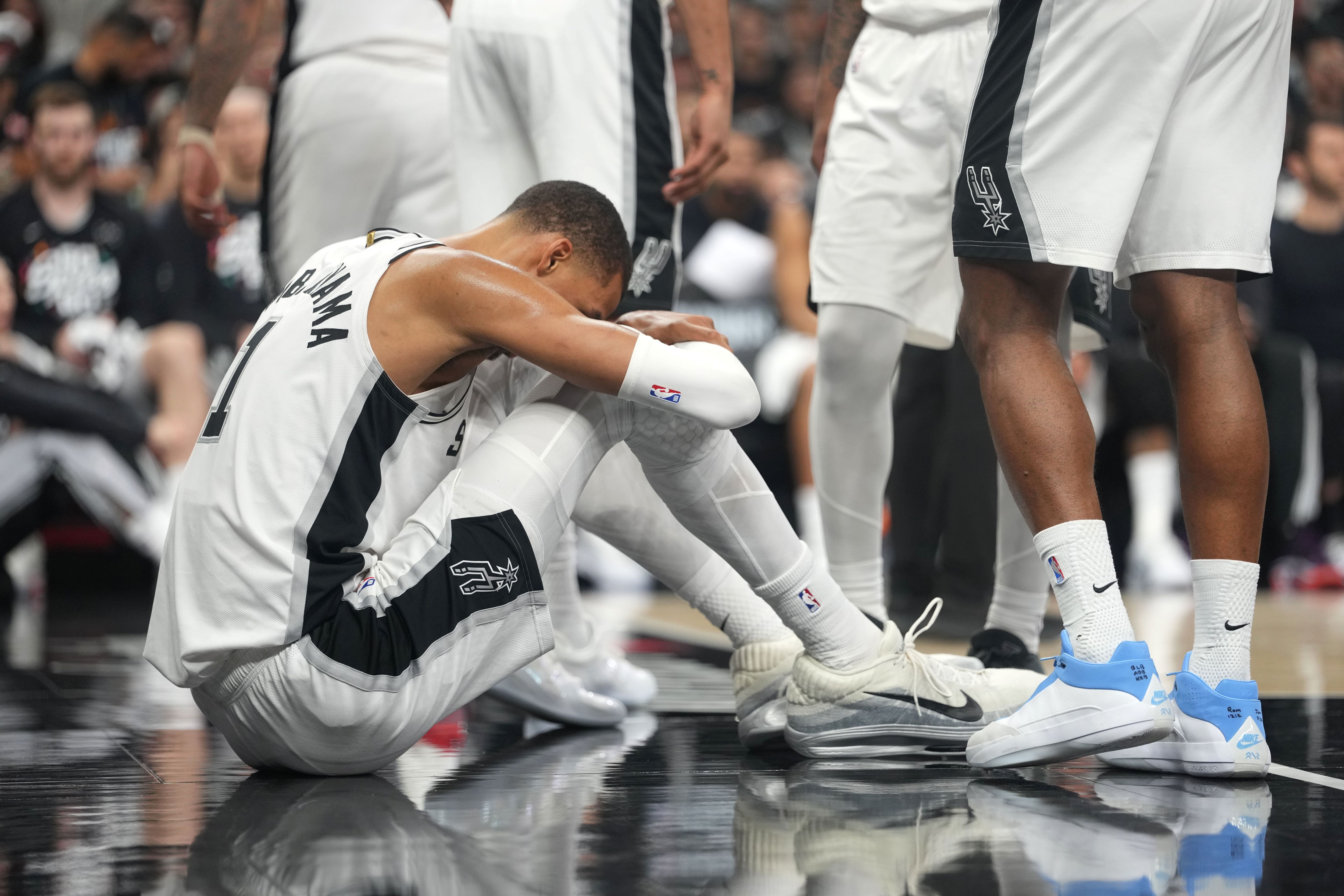 San Antonio Spurs forward Victor Wembanyama (1) reacts after falling to the ground during the first half of Game 2 against the Portland Trail Blazers at Frost Bank Center.