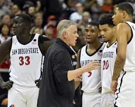 Head coach Brian Dutcher of the San Diego State Aztecs talks to his players during the Mountain West basketball tournament at the Thomas & Mack Center in Las Vegas, Nevada. Photo by David Becker/Getty Images via AFP.