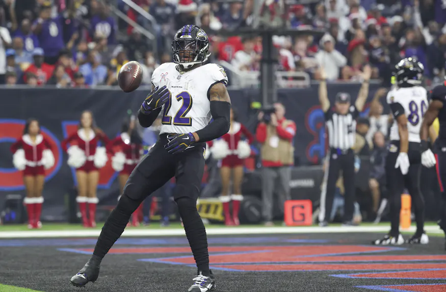 Baltimore Ravens running back Derrick Henry tosses the ball after scoring a touchdown against the Houston Texans, and we offer our best Derrick Henry player prop picks for Wild Card Weekend.