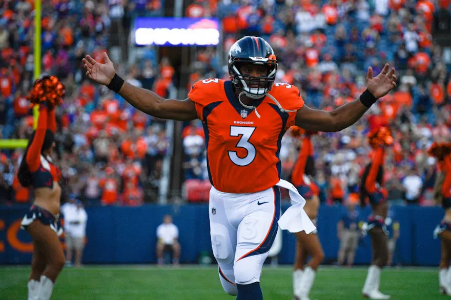 Quarterback Russell Wilson of the Denver Broncos runs onto the field before a preseason game against the Minnesota Vikings at Empower Field at Mile High on August 27, 2022 in Denver, Colorado.