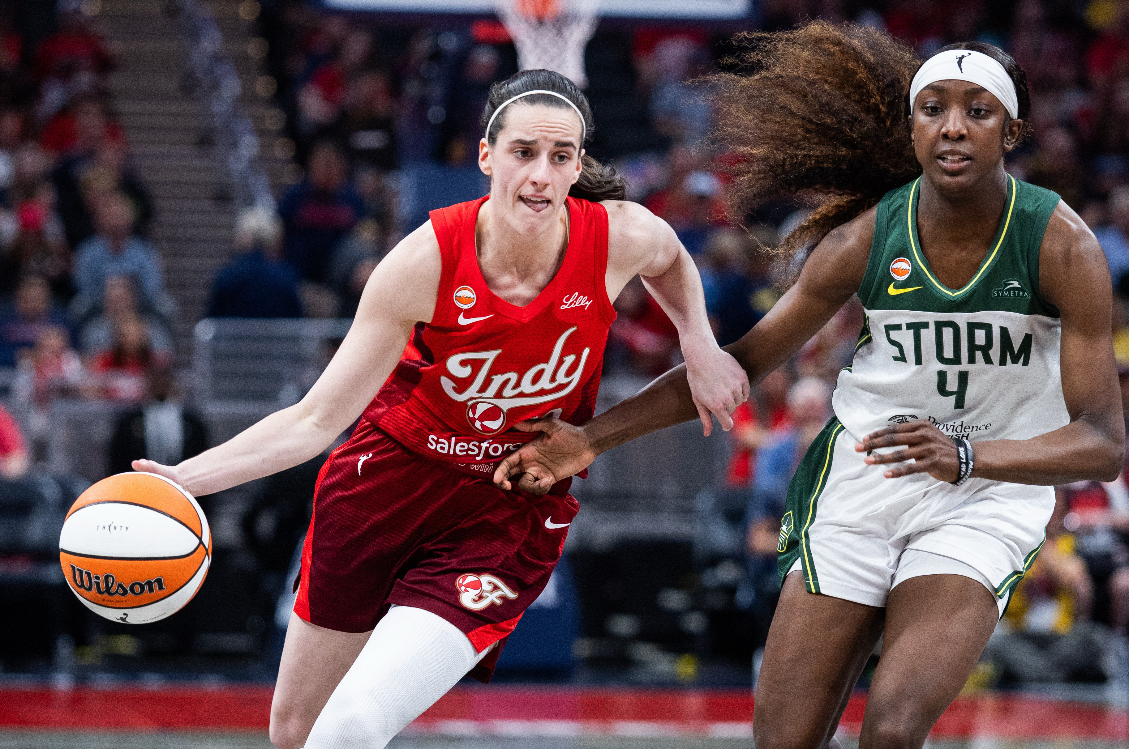 Indiana Fever guard Caitlin Clark (22) dribbles as we break down our Fever vs. Storm prediction.