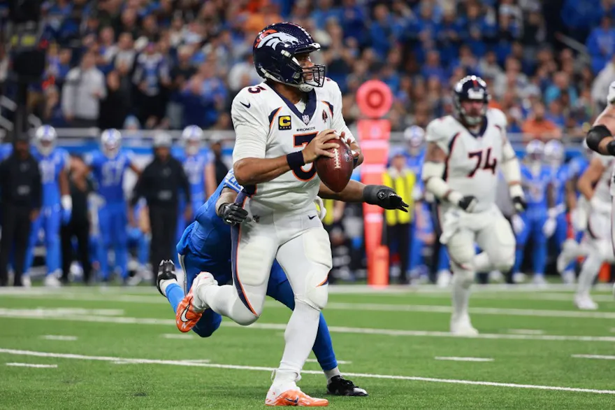Russell Wilson looks to pass during the first half ahead of our Week 16 NFL predictions for Patriots vs. Chiefs