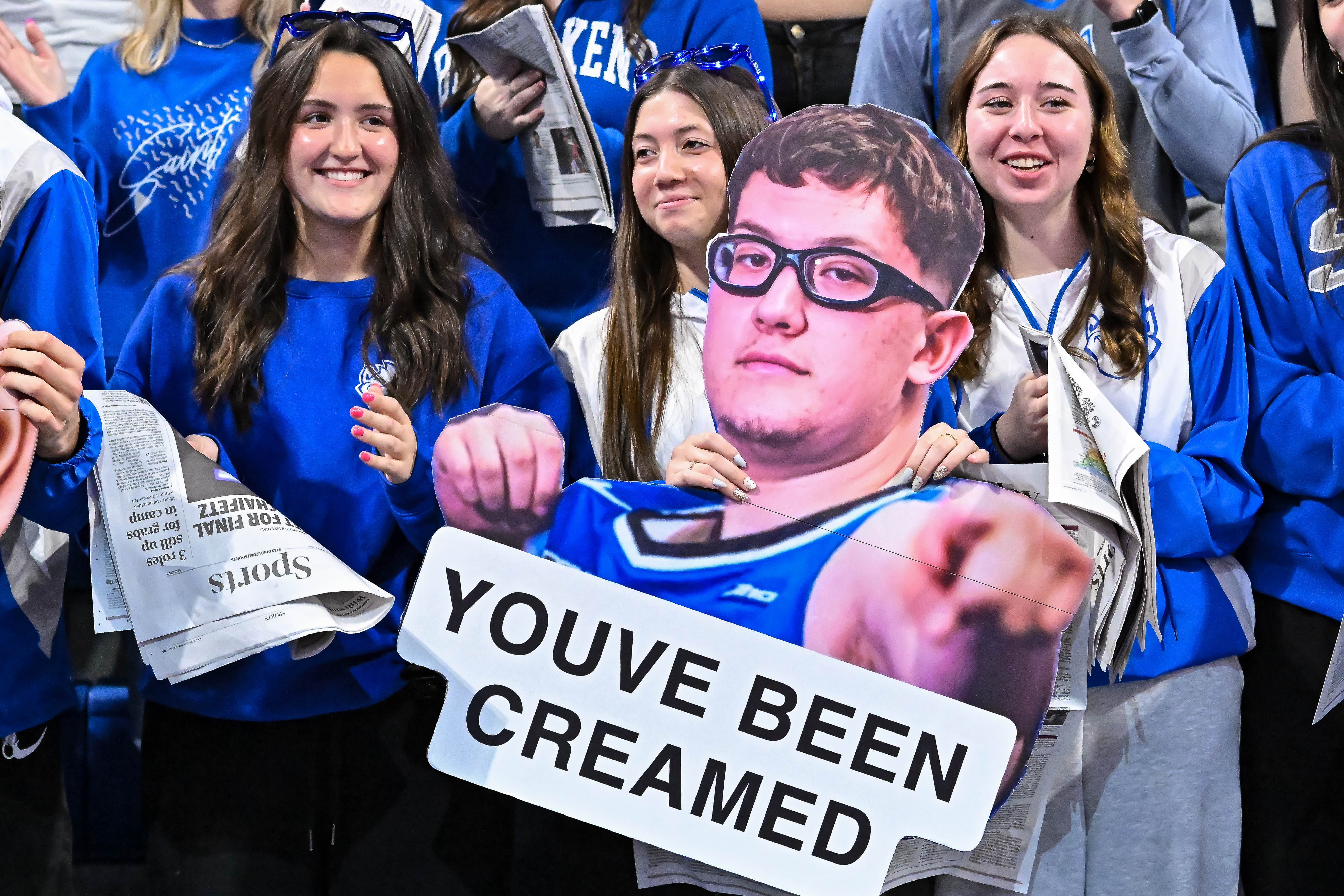 Members of the Saint Louis student section hold a cutout of Saint Louis center Robbie Avila (21) as we cover all you need to know about Cream Abdul-Jabbar ahead of the 2026 NCAA Tournament
