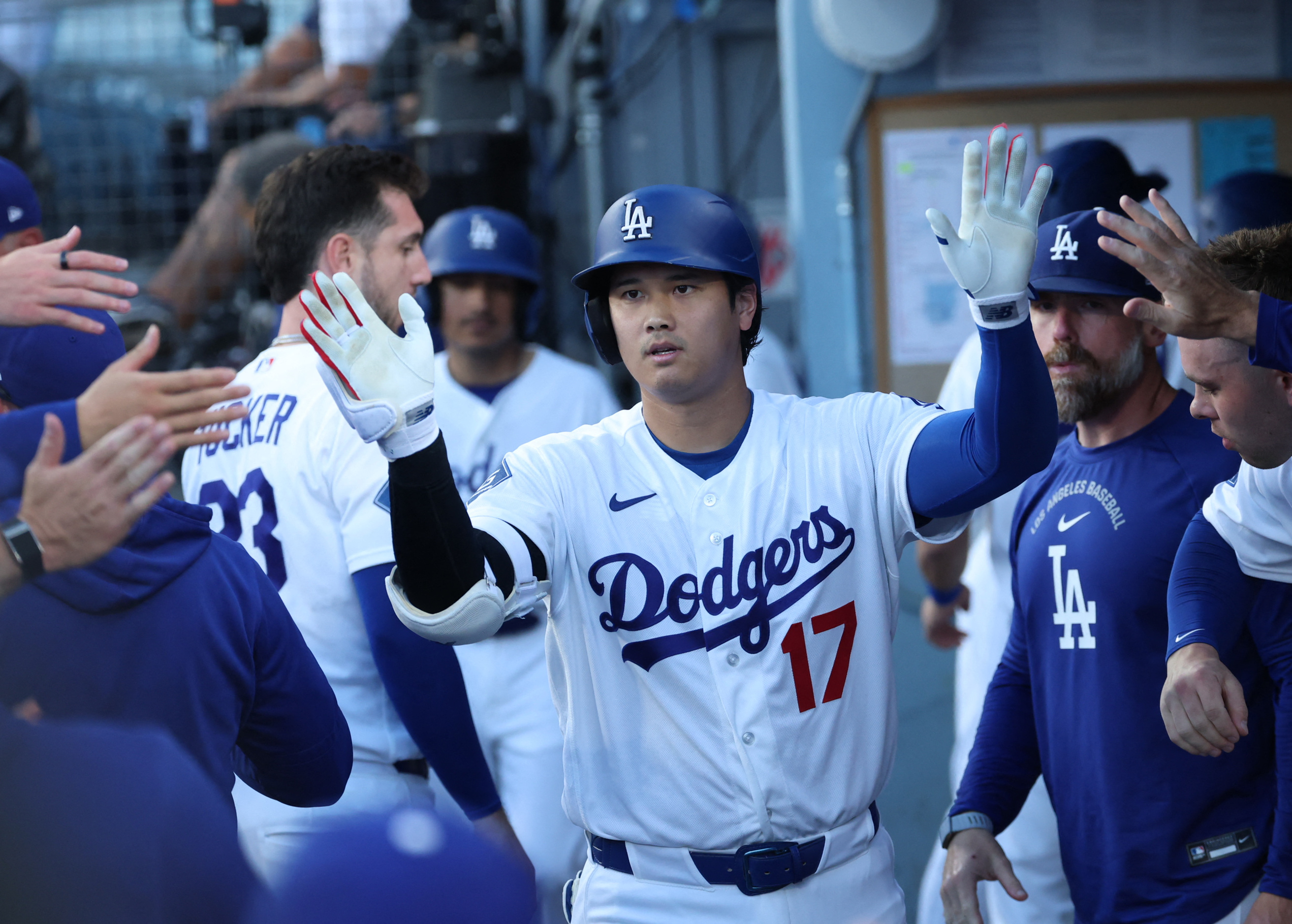 Los Angeles Dodgers designated hitter Shohei Ohtani (17) high-fives teammates after a home run during the first inning against the Arizona Diamondbacks at Dodger Stadium.