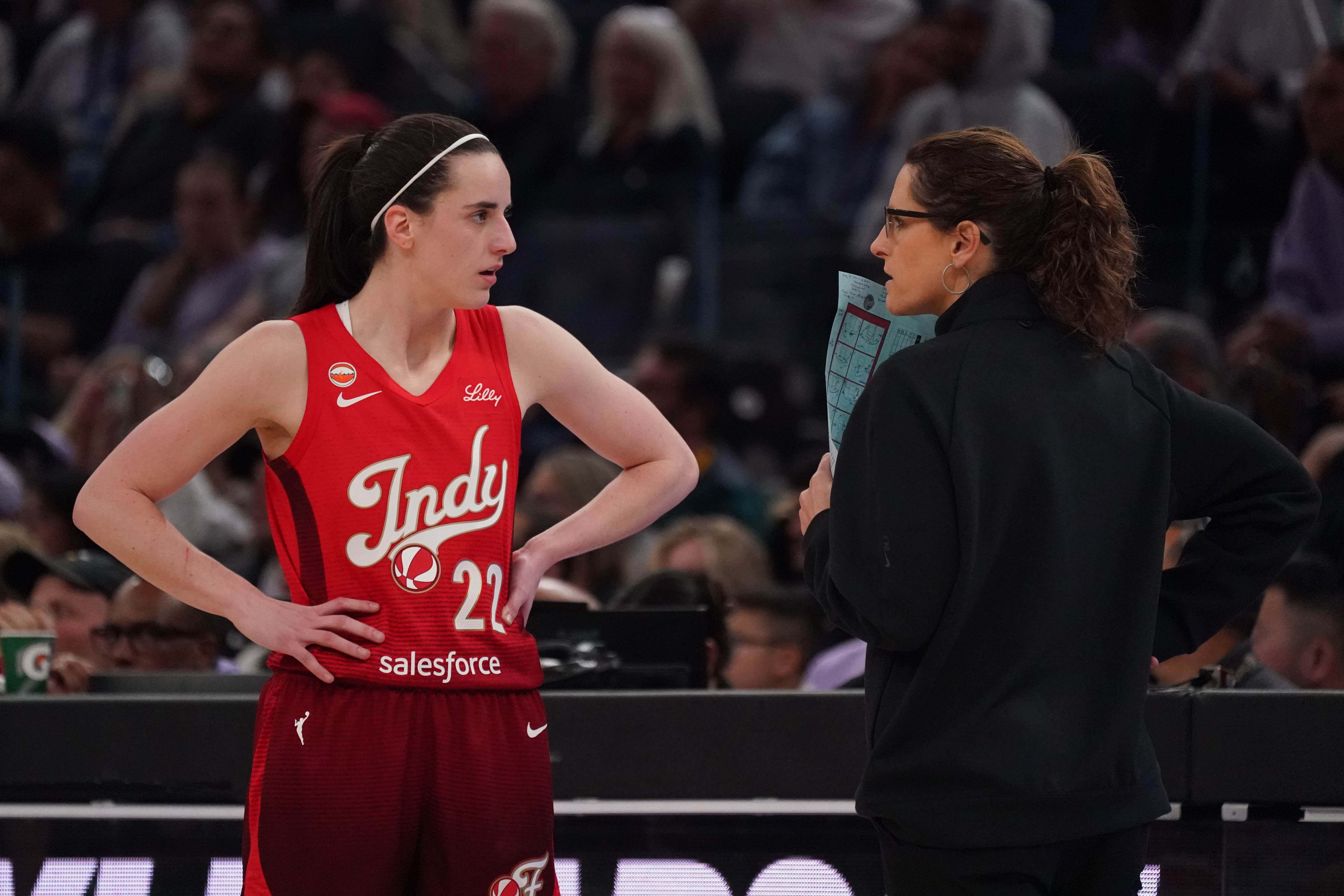 Indiana Fever guard Caitlin Clark (22) talks with head coach Stephanie White as we break down the Caitlin Clark next team odds.