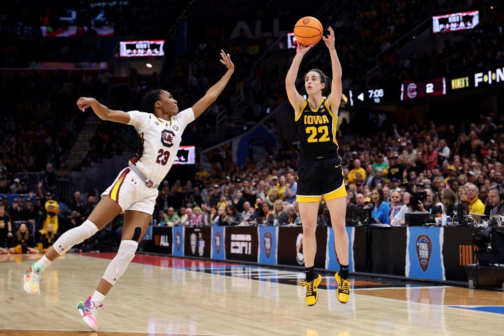 Caitlin Clark of the Iowa Hawkeyes shoots a three point basket over Bree Hall of the South Carolina Gamecocks in the first half during the 2024 NCAA Women