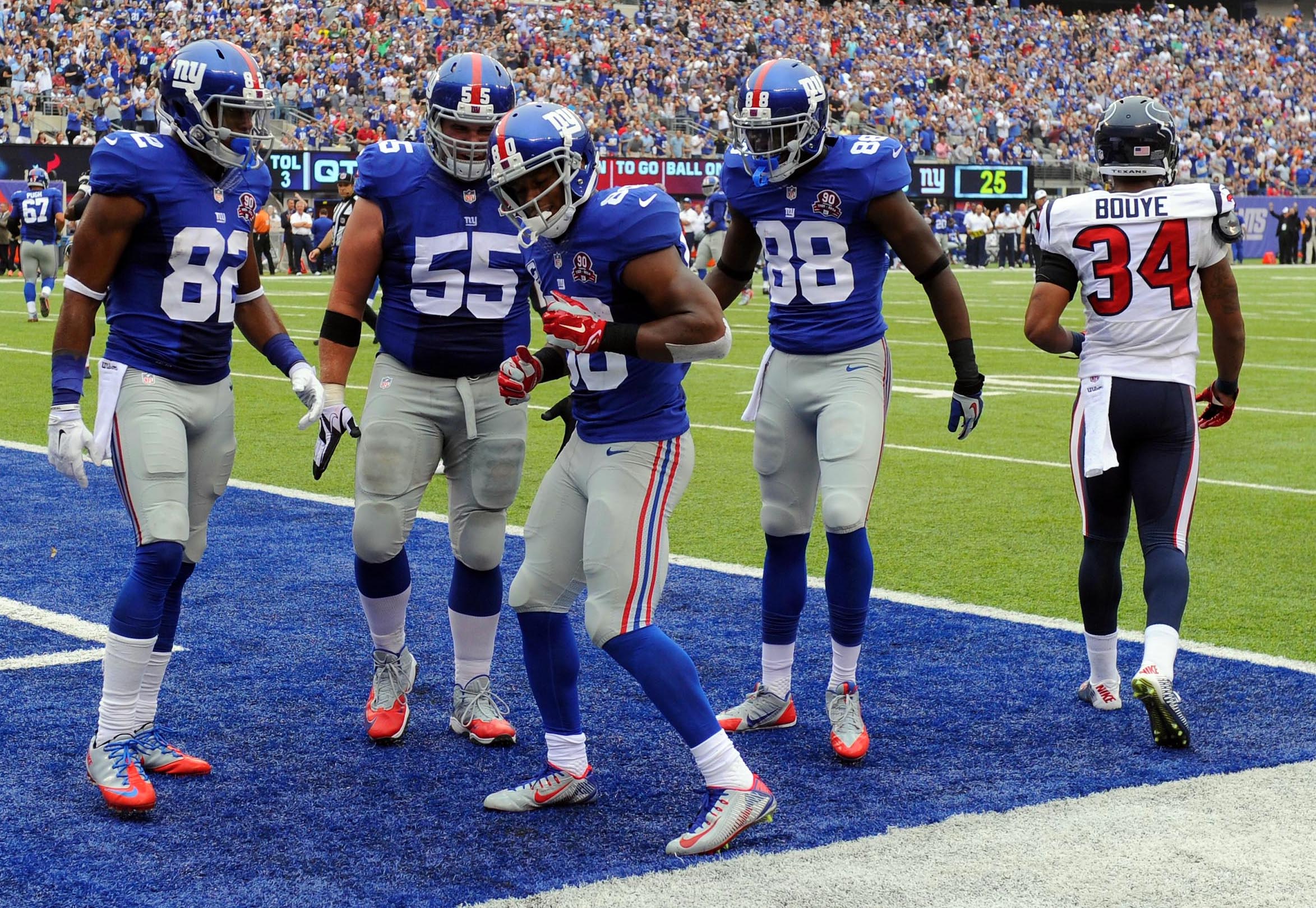 New York Giants wide receiver Victor Cruz (80), seen here celebrating a touchdown with teammates, is featured in our 10 best Latino players in Super Bowl history.