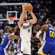 Domantas Sabonis of the Sacramento Kings is guarded by Chris Paul and Jonathan Kuminga of the Golden State Warriors in the second half during the Play-In Tournament. We're backing Sabonis in our Kings vs. Pelicans player props. 