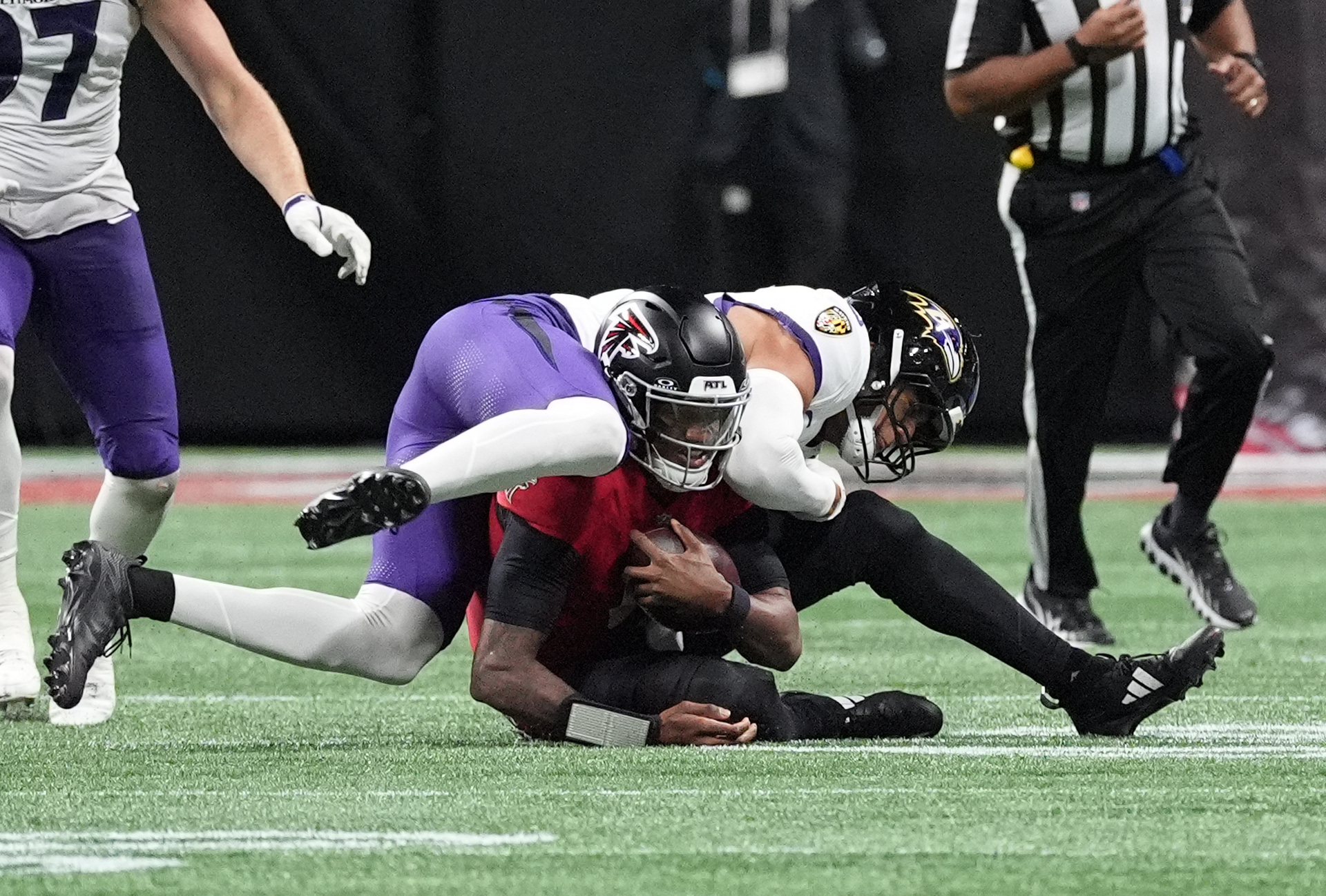 Baltimore Ravens safety Kyle Hamilton tackles Atlanta Falcons quarterback Michael Penix Jr. as we look at the Week 6 NFL injuries