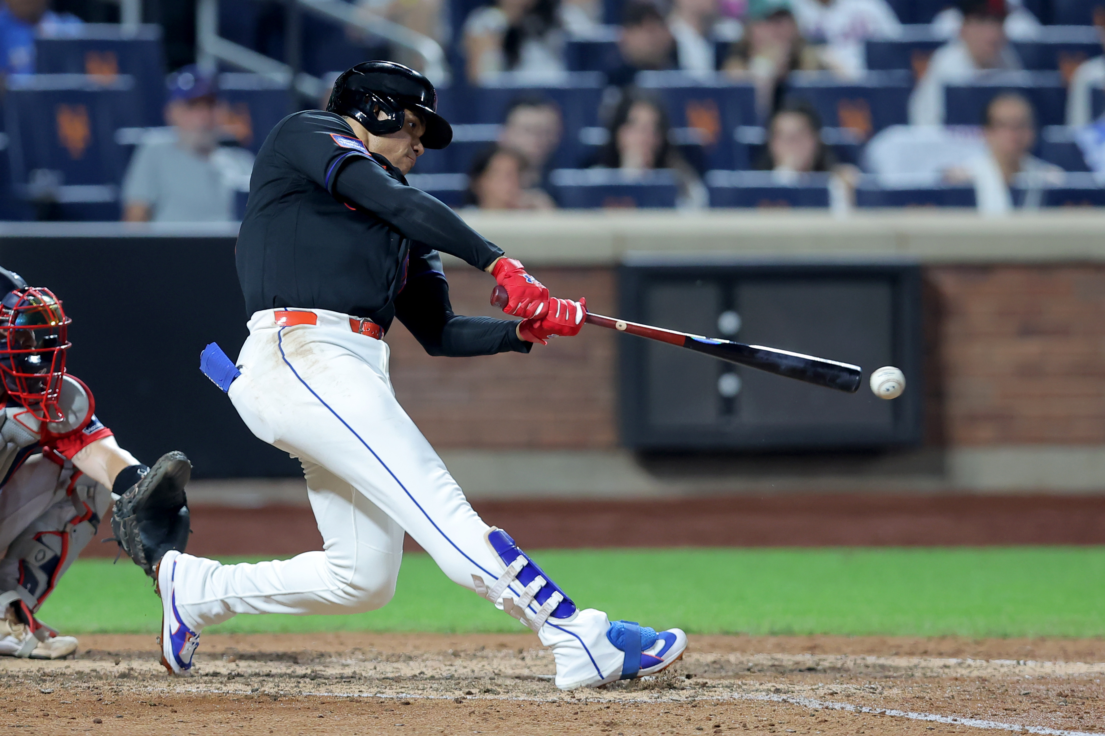  New York Mets left fielder Juan Soto (22) hits a single against the Boston Red Sox during the eighth inning at Citi Field.