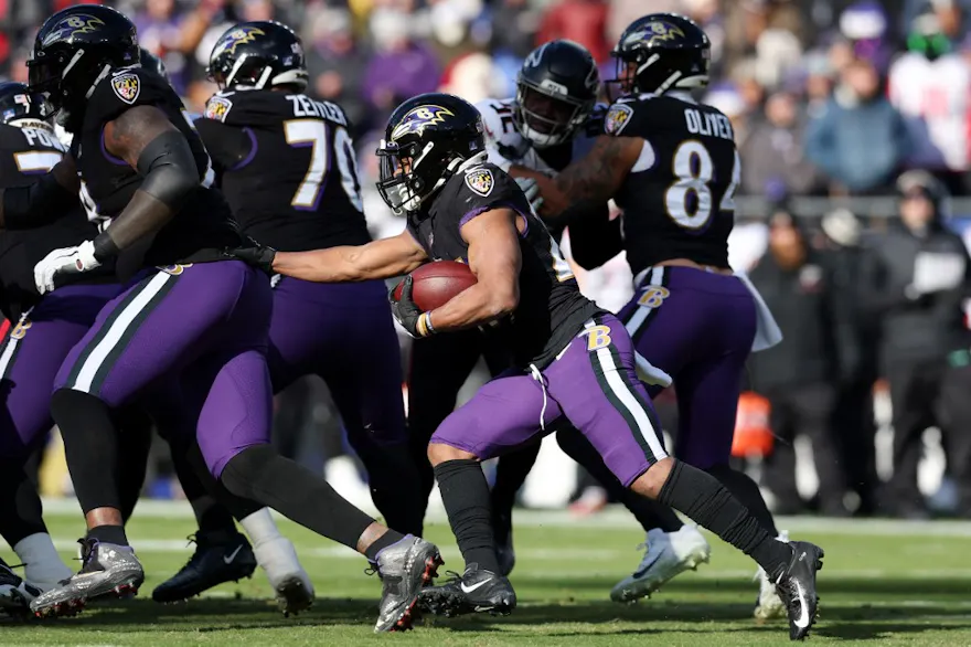 J.K. Dobbins of the Baltimore Ravens carries the ball during the first quarter of the game against the Atlanta Falcons at M&T Bank Stadium on December 24, 2022 in Baltimore, Maryland.