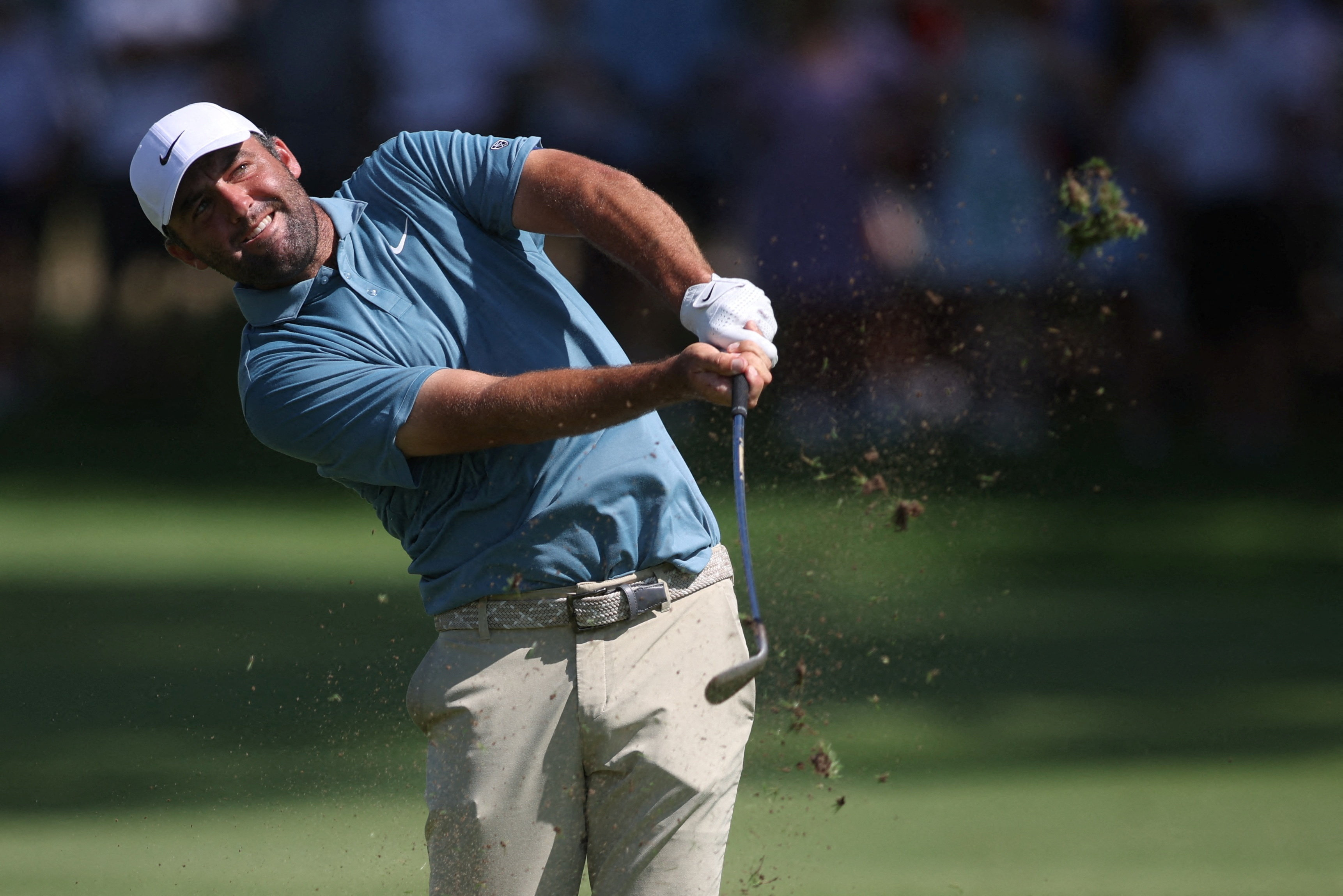 Scottie Scheffler hits the ball as he is featured in our Presidents Cup picks & predictions.