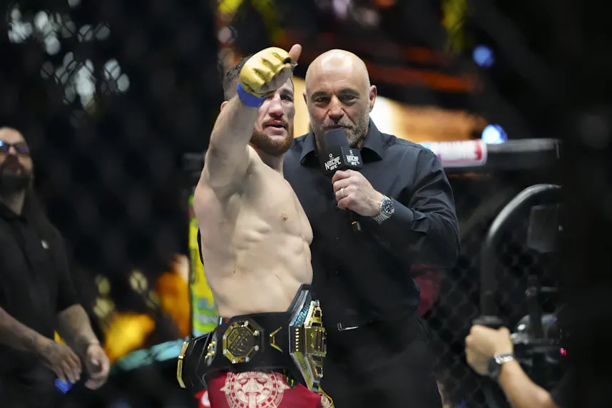 Merab Dvalishvili celebrates a win in the Octagon with Joe Rogan as we look at our Merab Dvalishvili vs. Umar Nurmagomedov prediction.