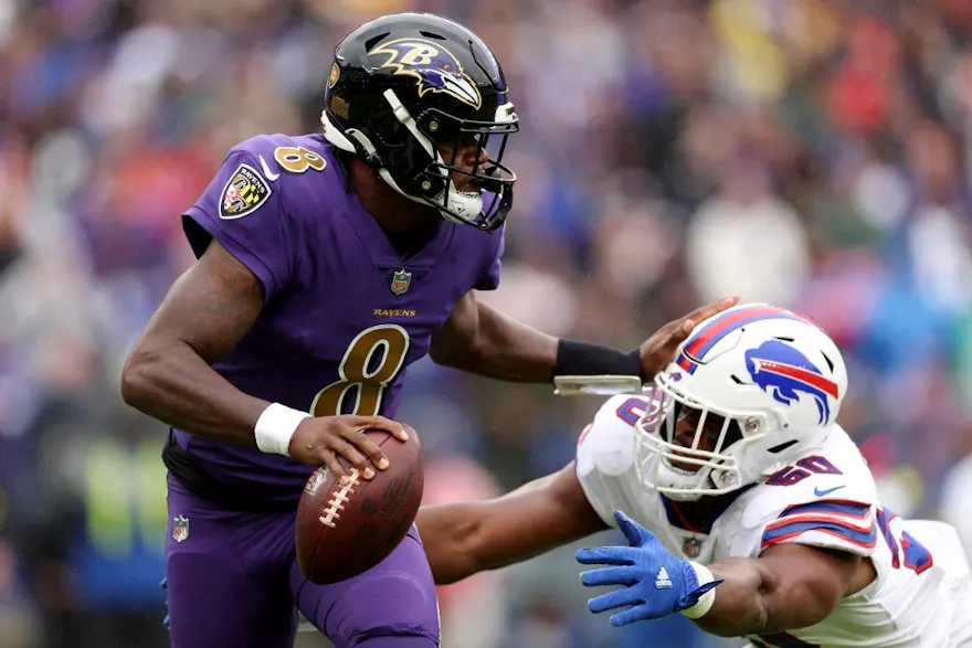 Lamar Jackson of the Baltimore Ravens drops back to pass while Greg Rousseau of the Buffalo Bills chases him at M&T Bank Stadium on Oct. 02, 2022 in Baltimore, Maryland.