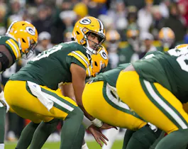 Green Bay Packers quarterback Jordan Love (10) prepares to take a snap as we offer our FanDuel promo code for Dolphins vs. Packers.