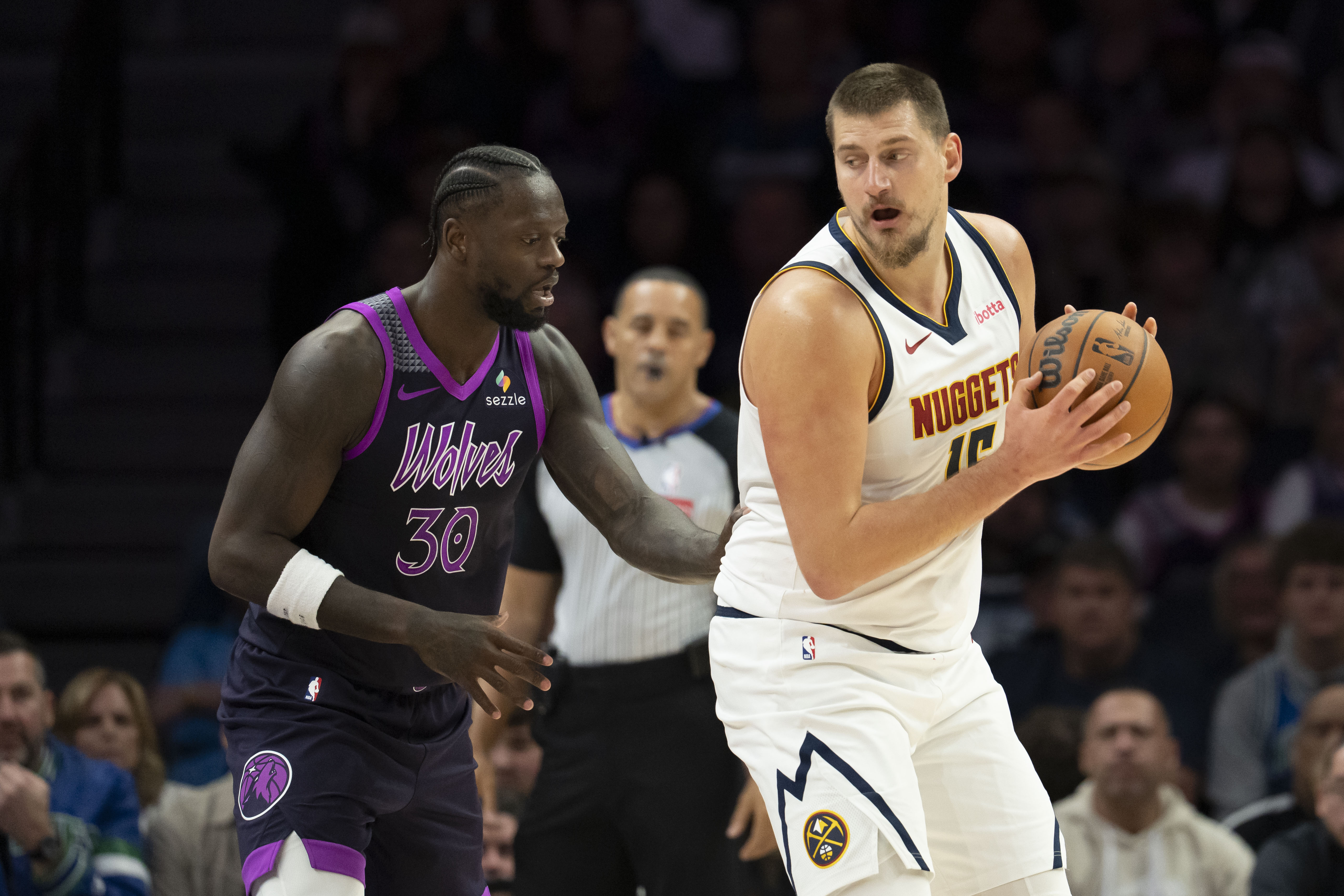 Denver Nuggets center Nikola Jokic (15) dribbles the ball against Minnesota Timberwolves forward Julius Randle (30) as we break down our NBA Christmas Day predictions.