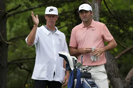 Scottie Scheffler and caddie Ted Scott prepare to play a shot as we look at the U.S. Open odds.