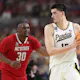 Zach Edey of the Purdue Boilermakers handles the ball while being guarded by D.J. Burns Jr. of the NC State Wolfpack in the NCAA Men's Basketball Tournament Final Four semifinal game. We're looking at our Purdue vs. UConn Zach Edey play props. 