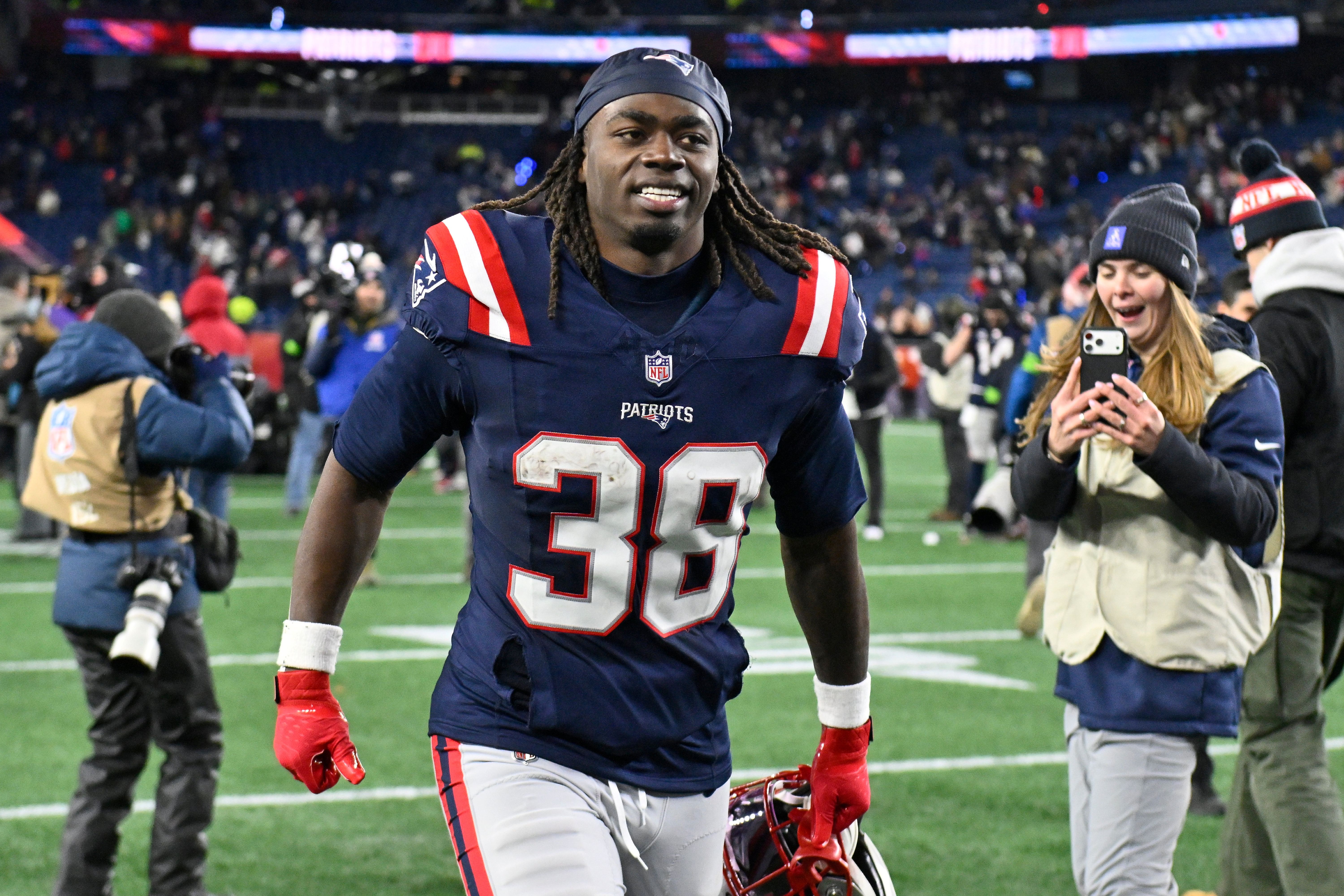 New England Patriots running back Rhamondre Stevenson jogs off the field, and he's key as we look at our Patriots vs. Broncos same game parlay..