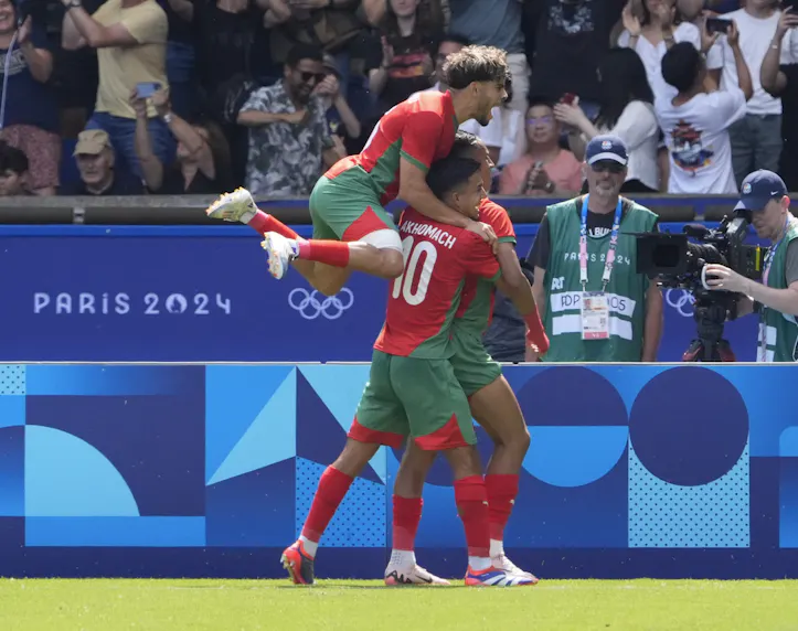 Morocco forward Soufiane Rahimi celebrates with teammates after scoring a goal as we offer our best picks and predictions for the bronze medal game between Morocco and Egypt.