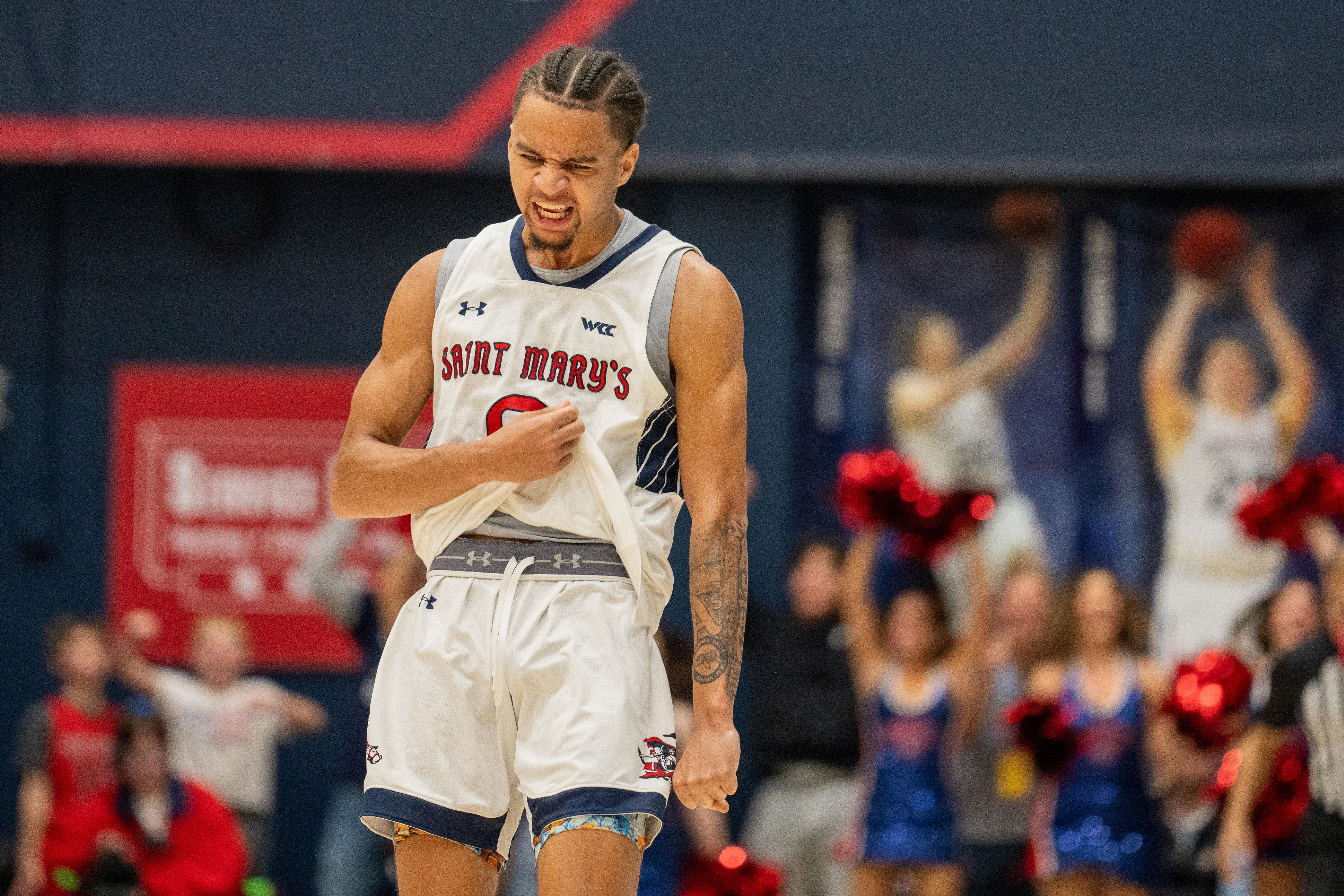 St. Mary's Gaels guard Mikey Lewis celebrates, and he's key as we look at our Saint Mary's vs. Gonzaga prediction.