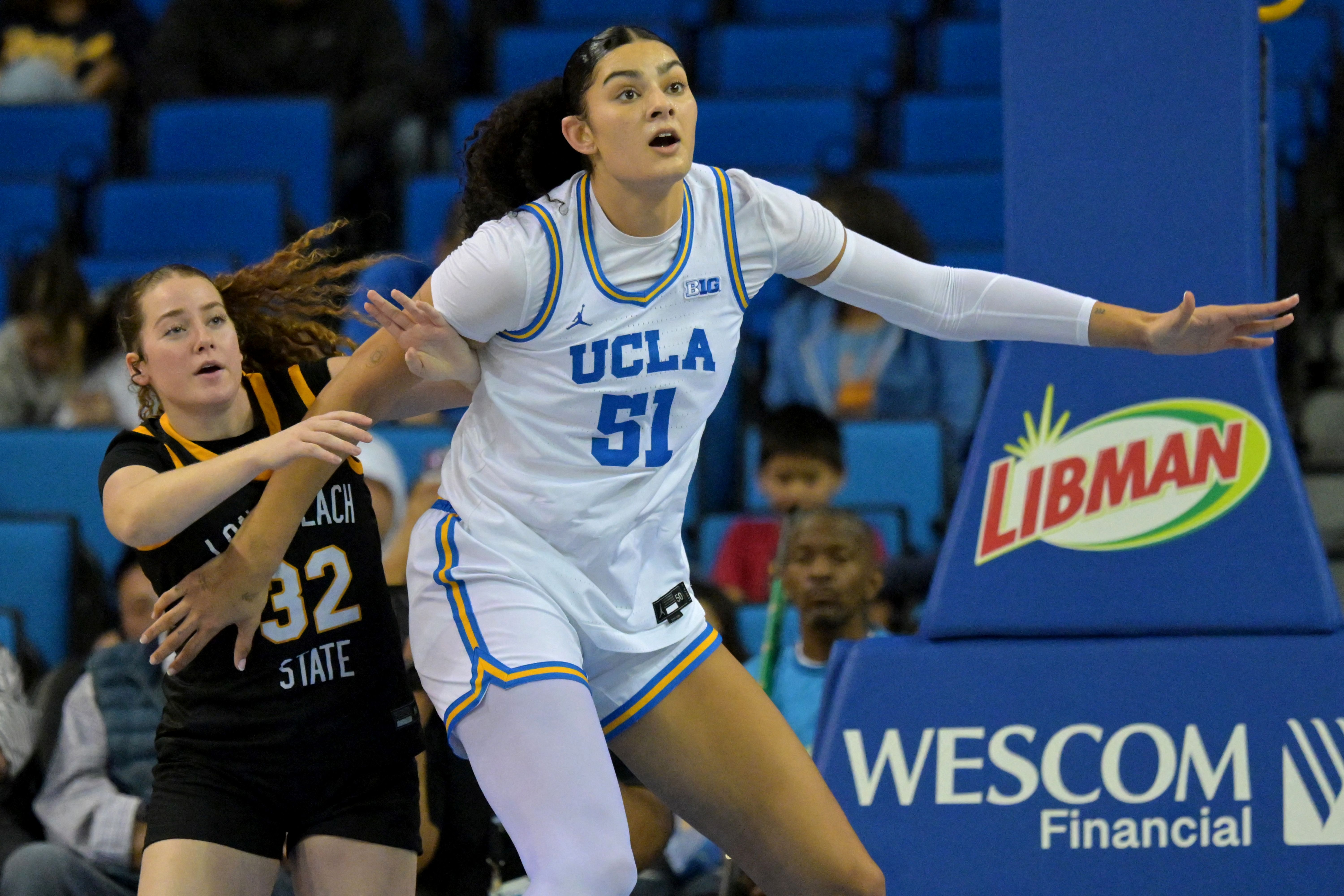 UCLA Bruins center Lauren Betts boxes out, and she's featured as part of our Duke vs. UCLA prediction.