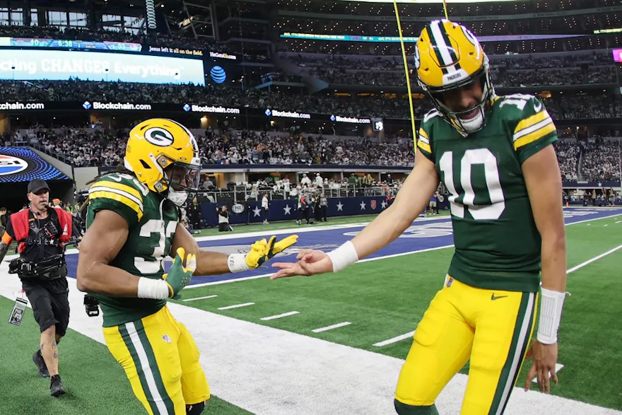 Aaron Jones #33 of the Green Bay Packers celebrates a touchdown with Jordan Love #10 following a second half touchdown as we look at the opening odds for the 2024 NFL Divisional Round