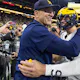 Head coach Jim Harbaugh celebrates with J.J. McCarthy of the Michigan Wolverines after winning the Big Ten Championship against the Iowa Hawkeyes as we look at our Washington-Michigan prediction.