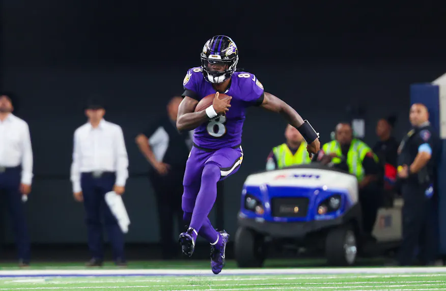 Baltimore Ravens quarterback Lamar Jackson runs with the ball as we offer our Bills vs. Ravens prop bets for Sunday Night Football.