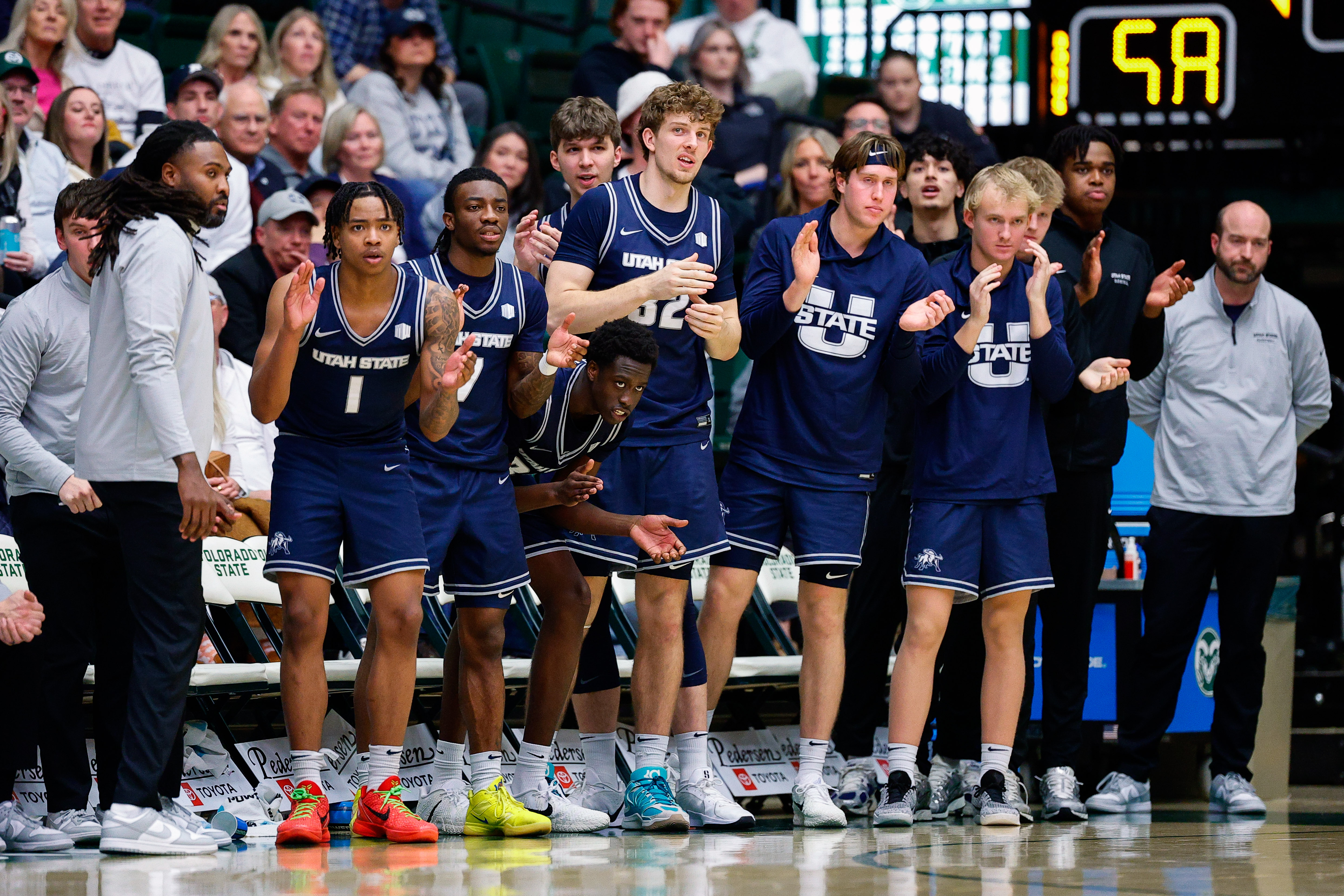 Utah State Aggies players react from the bench as we make our best Utah State vs. Villanova prediction.